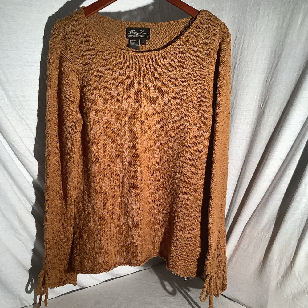 Terry Lewis, golden brown, loose knit sweater.